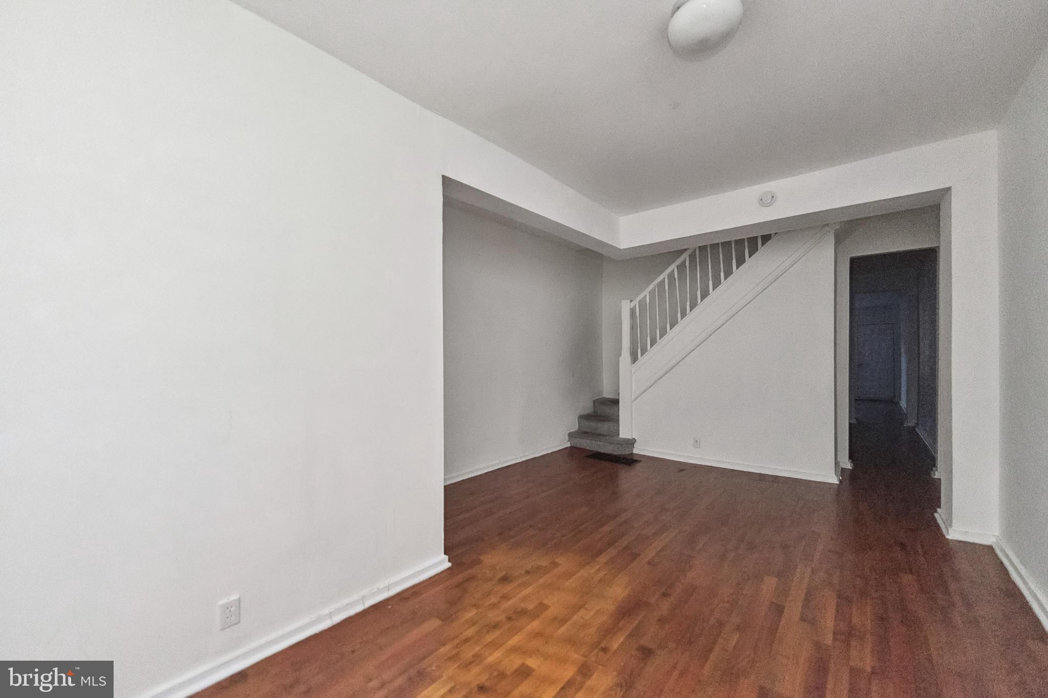 1828 Walbrook Avenue Baltimore, MD 21217 - Photo 4 of 15 a view of an empty room with wooden floor
