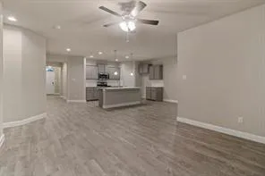 a view of a kitchen with a sink and a refrigerator