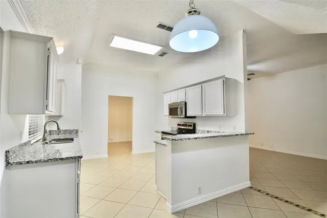 a kitchen with stainless steel appliances a sink stove and refrigerator