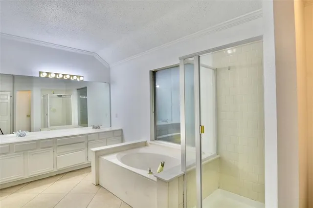 a bathroom with a tub a sink and a shower