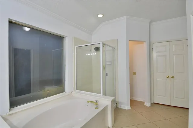 a bathroom with a shower and a tub