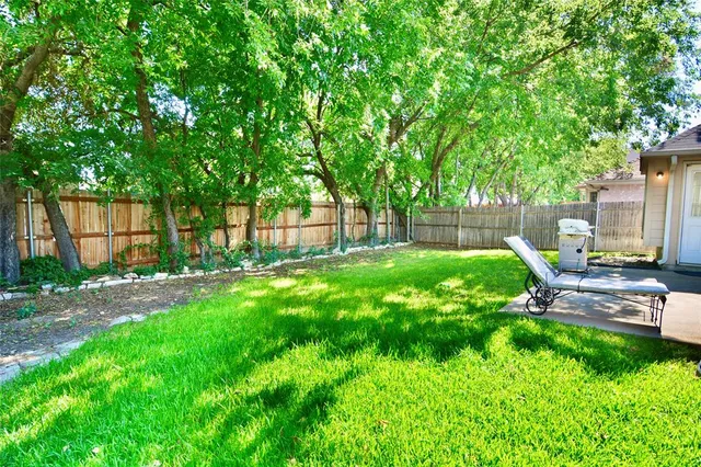 a view of backyard with a garden and swimming pool