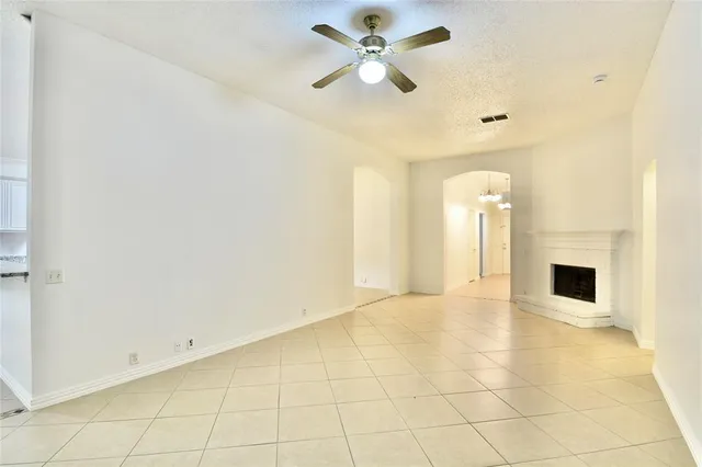 a view of an empty room with a ceiling fan
