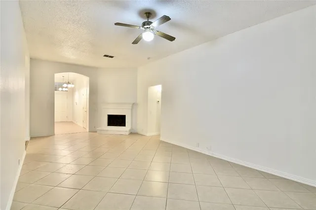 a view of an empty room with a ceiling fan