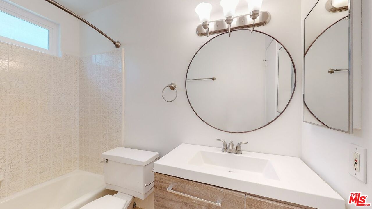 1827 Manning Avenue, Unit 6 Los Angeles, CA 90025 - Photo 15 of 22 a bathroom with a sink and a mirror
