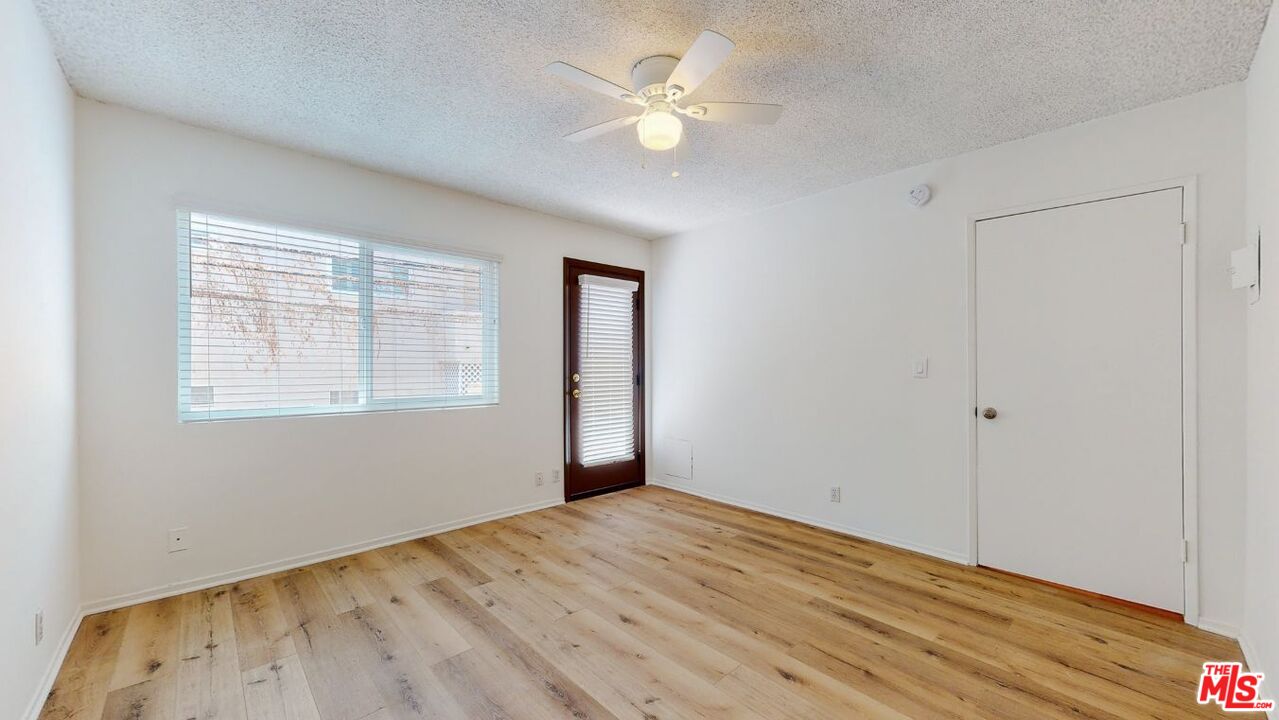 1827 Manning Avenue, Unit 6 Los Angeles, CA 90025 - Photo 16 of 22 a view of empty room with wooden floor and fan