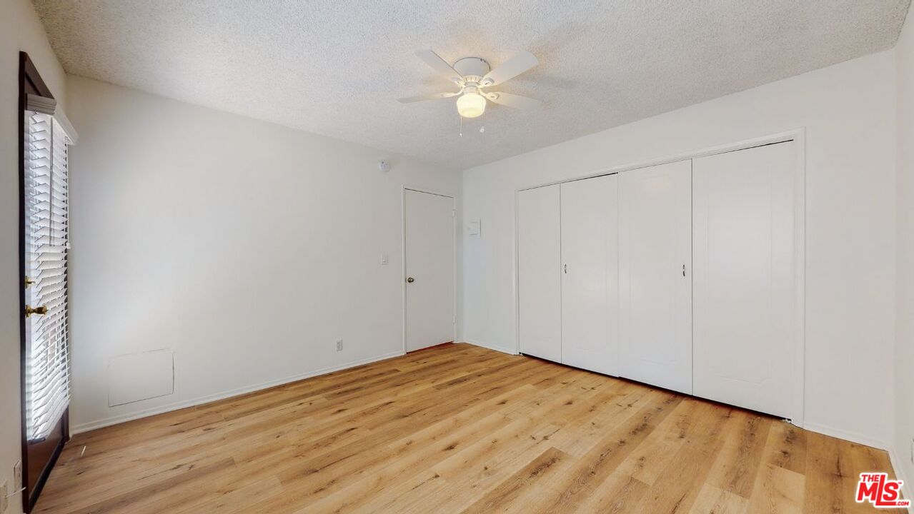 1827 Manning Avenue, Unit 6 Los Angeles, CA 90025 - Photo 17 of 22 a view of an empty room with wooden floor