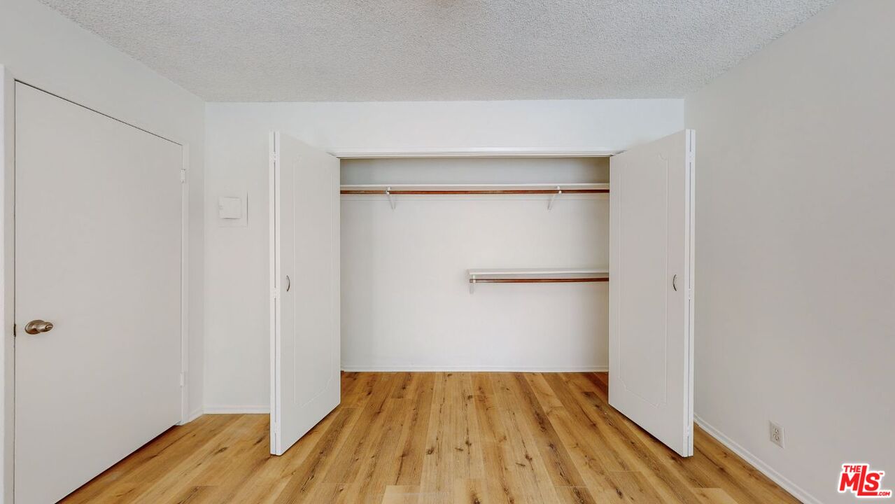 1827 Manning Avenue, Unit 6 Los Angeles, CA 90025 - Photo 19 of 22 an empty room with wooden floor and closet