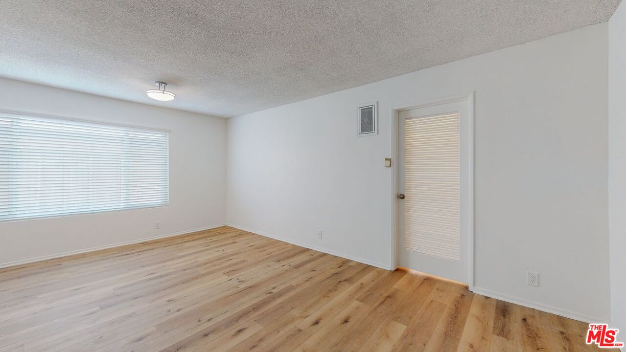 1827 Manning Avenue, Unit 6 Los Angeles, CA 90025 - Photo 4 of 22 a view of empty room with wooden floor