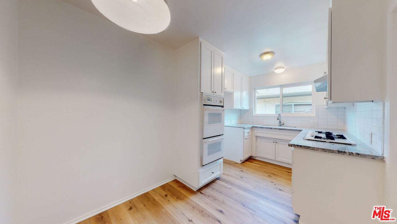 1827 Manning Avenue, Unit 6 Los Angeles, CA 90025 - Photo 8 of 22 a kitchen with a refrigerator and a stove top oven
