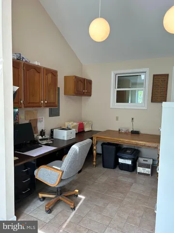 a living room with furniture a window and bookshelf
