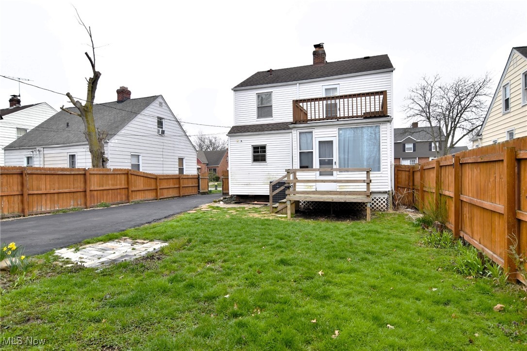 3921 Grosvenor Road Cleveland, OH 44118 - Photo 44 of 46 Rear view of property featuring a balcony, a fenced backyard, a wooden deck, and a chimney