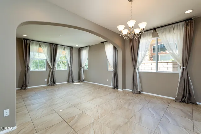 a large kitchen with stainless steel appliances granite countertop a stove and a refrigerator