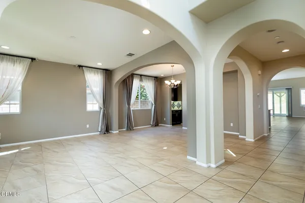 a view of an empty room with glass door and a window