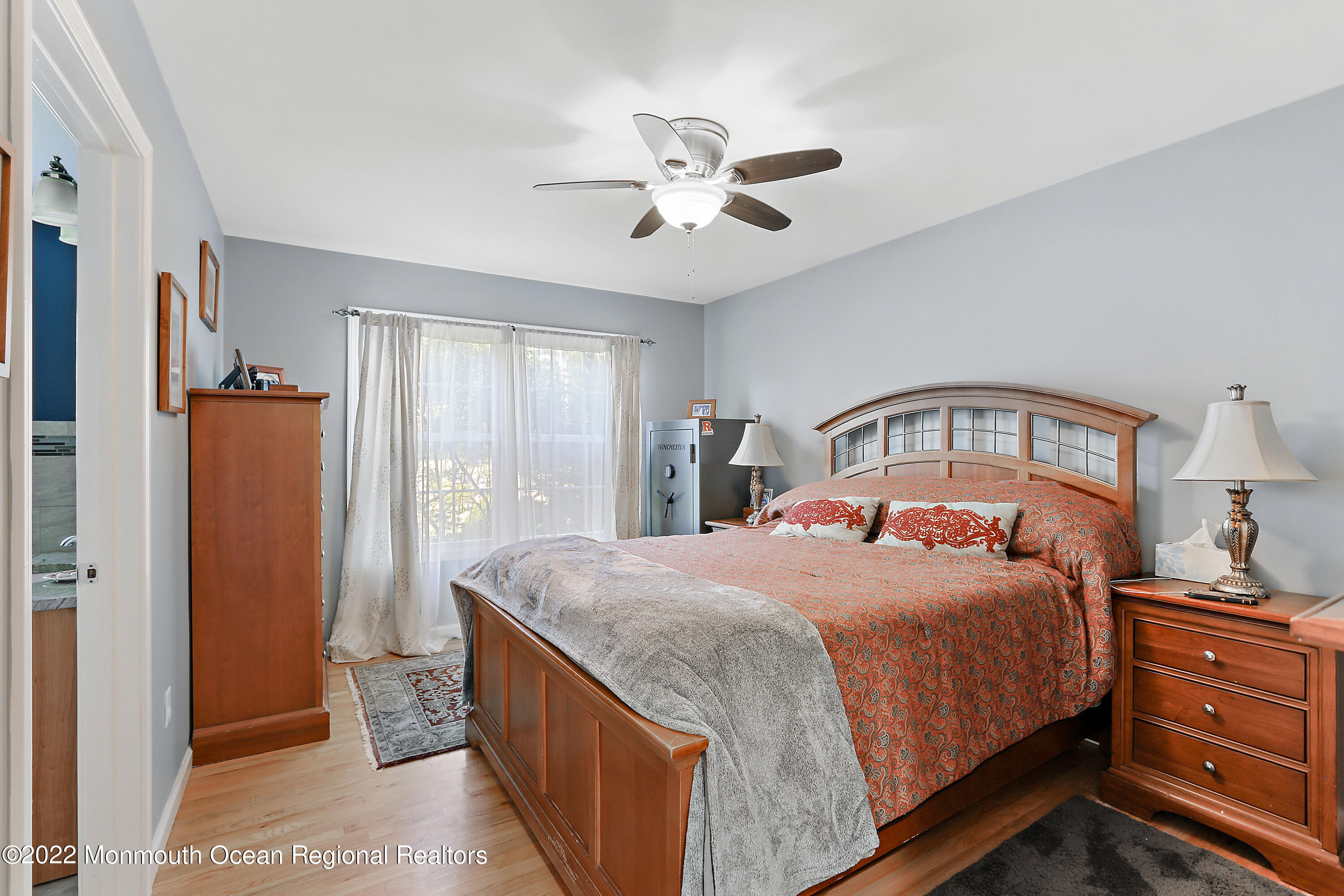 1849 Carmerville Road Wall, NJ 07719 - Photo 16 of 45 a bedroom with a large bed and a chandelier