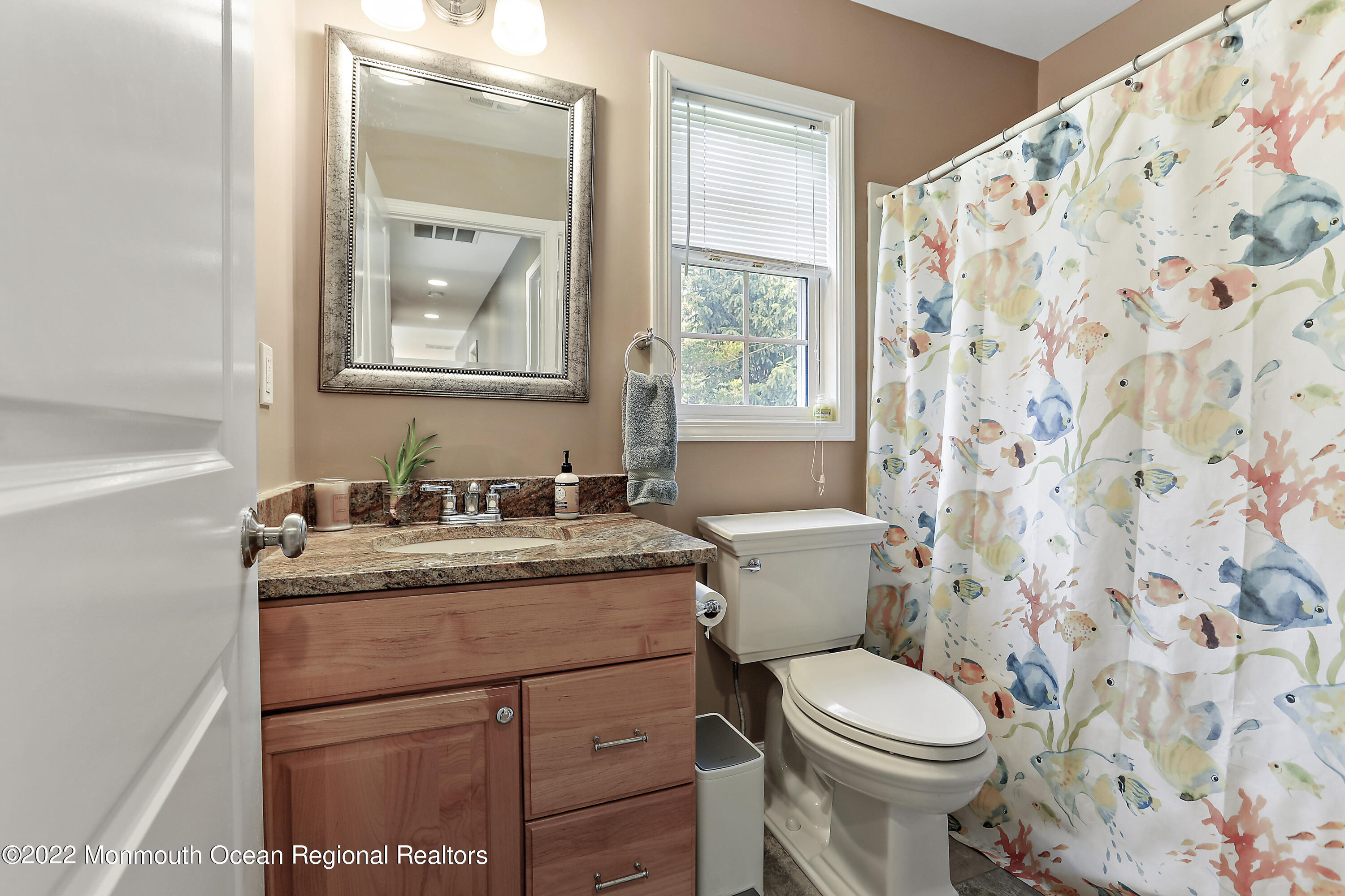 1849 Carmerville Road Wall, NJ 07719 - Photo 21 of 45 a bathroom with a granite countertop toilet a sink a mirror a window and a shower