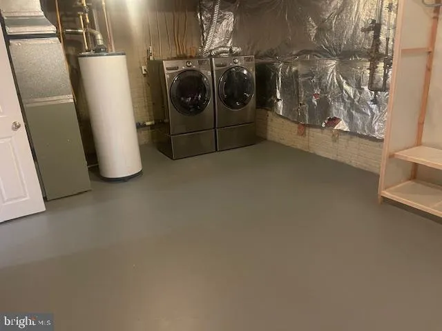 a utility room with a refrigerator and washer