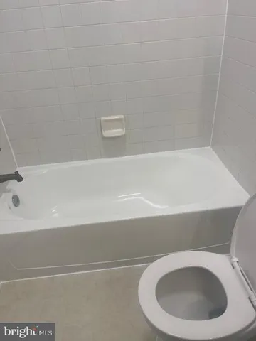 a bathroom with a toilet and bathtub