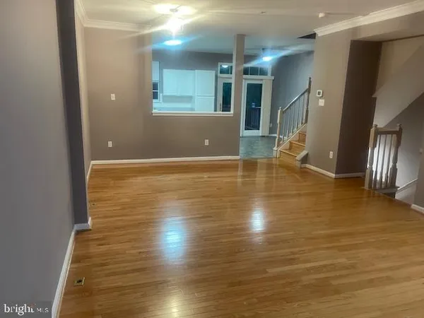 a view of a room with wooden floor