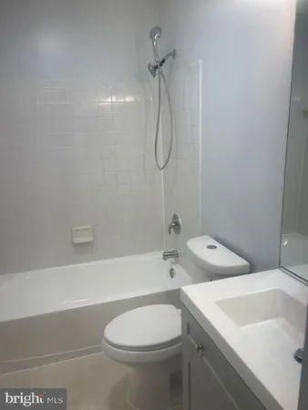 a bathroom with a sink a toilet and a bathtub