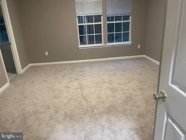 a view of empty room with windows