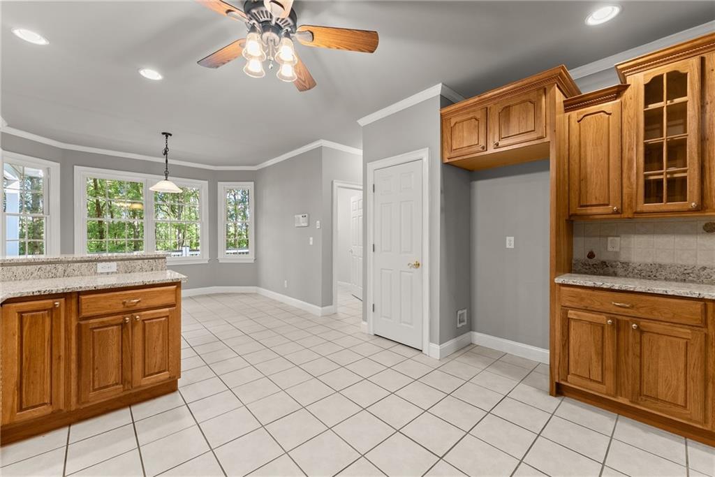 1040 Auburn Road Dacula, GA 30019 - Photo 12 of 65 a view of a kitchen with kitchen island granite countertop cabinets and window
