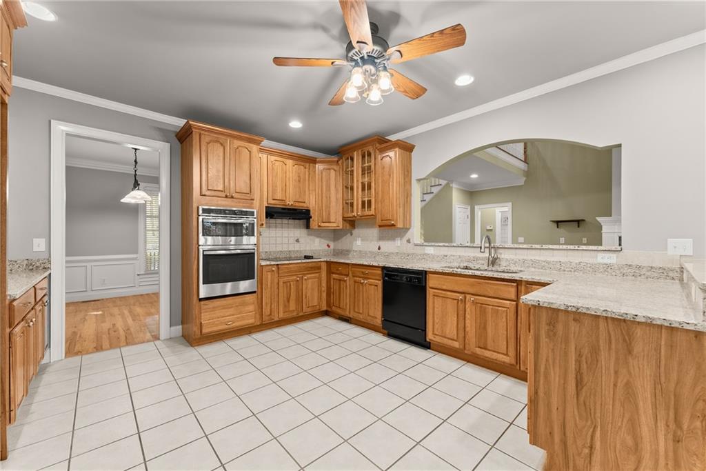 1040 Auburn Road Dacula, GA 30019 - Photo 13 of 65 a large kitchen with granite countertop a sink and cabinets