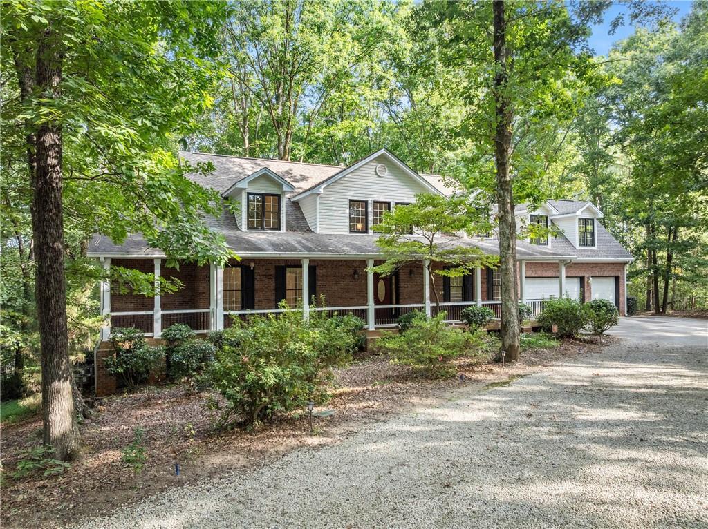 1040 Auburn Road Dacula, GA 30019 - Photo 2 of 65 a front view of a house with a garden