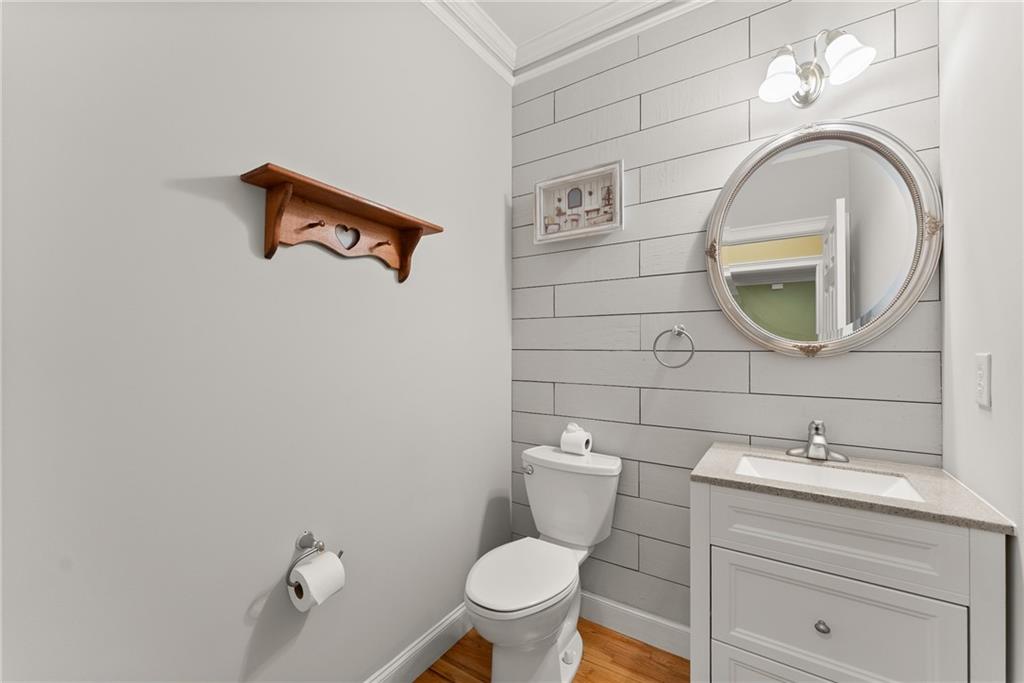 1040 Auburn Road Dacula, GA 30019 - Photo 21 of 65 a bathroom with a toilet sink and mirror