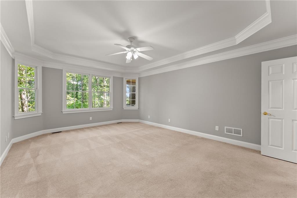 1040 Auburn Road Dacula, GA 30019 - Photo 25 of 65 an empty room with a ceiling fan and window