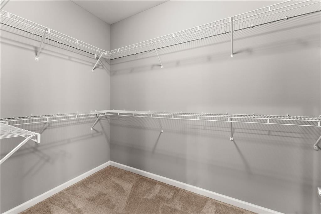 1040 Auburn Road Dacula, GA 30019 - Photo 30 of 65 a view of a room with racks on the wall