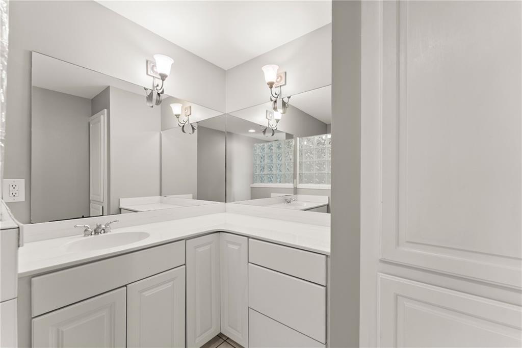 1040 Auburn Road Dacula, GA 30019 - Photo 40 of 65 a bathroom with a sink and a mirror