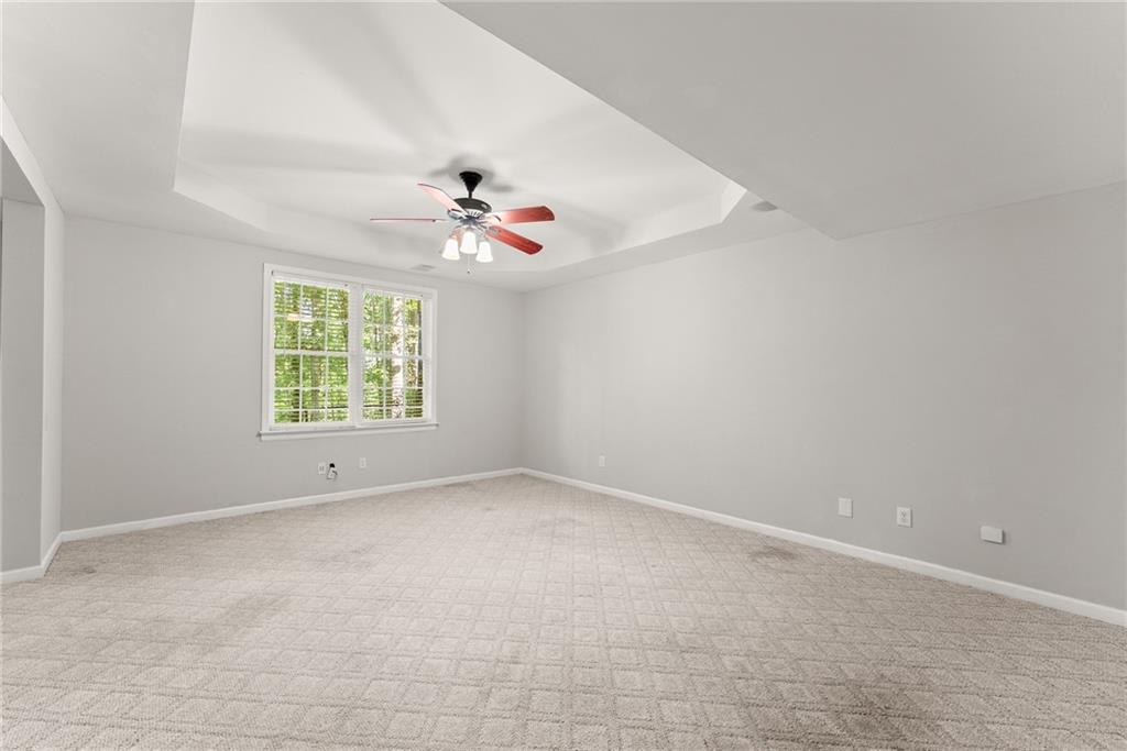 1040 Auburn Road Dacula, GA 30019 - Photo 50 of 65 an empty room with a window and a fan