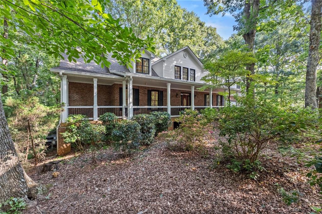 1040 Auburn Road Dacula, GA 30019 - Photo 5 of 65 a front view of a house with garden