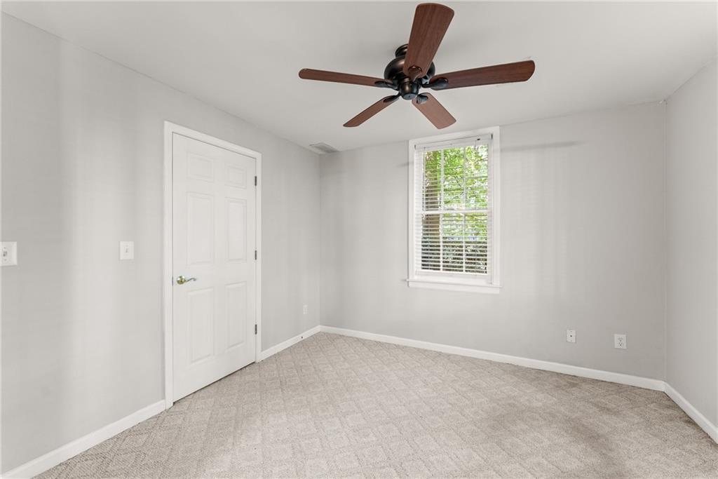 1040 Auburn Road Dacula, GA 30019 - Photo 52 of 65 a view of a room with a window and a ceiling fan