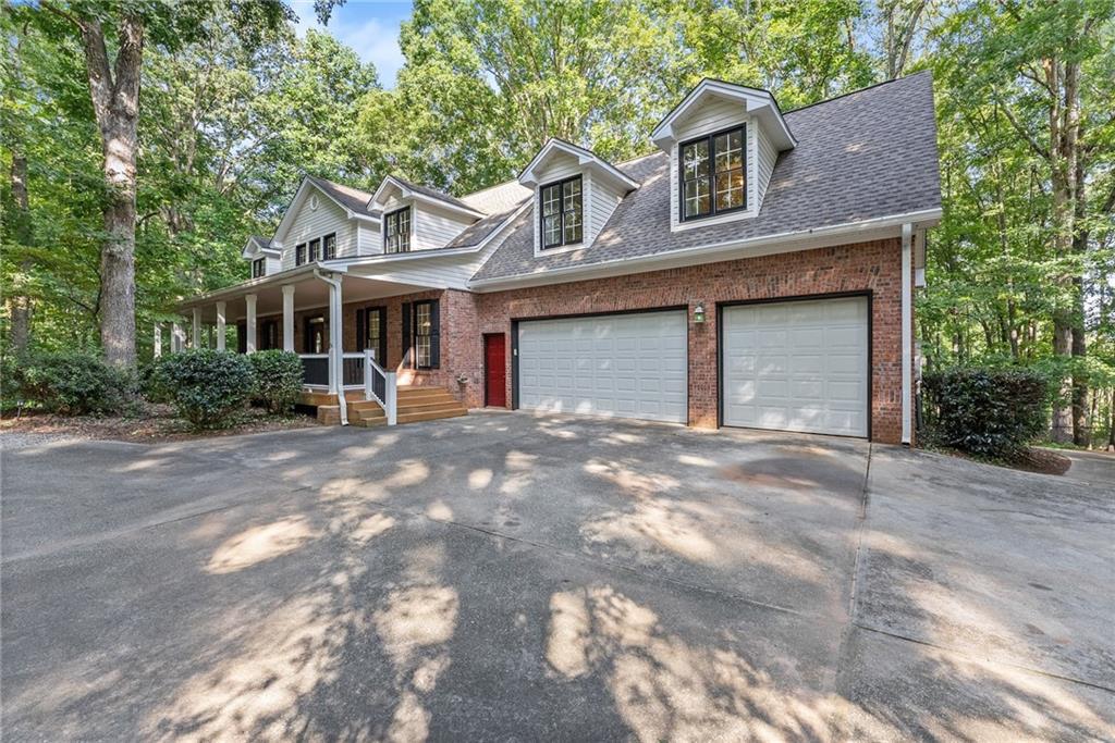 1040 Auburn Road Dacula, GA 30019 - Photo 6 of 65 a front view of a house with a yard and garage
