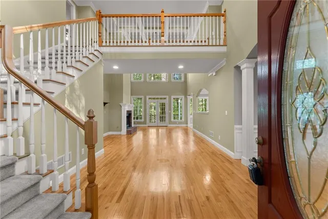 a view of a livingroom with wooden floor and staircase