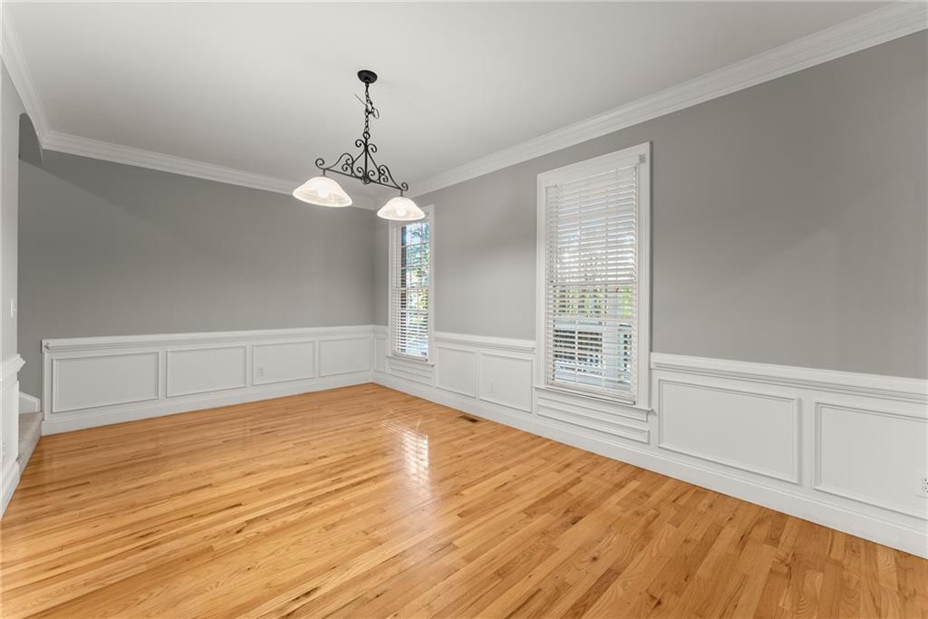 1040 Auburn Road Dacula, GA 30019 - Photo 9 of 65 a view of an empty room with wooden floor and a window