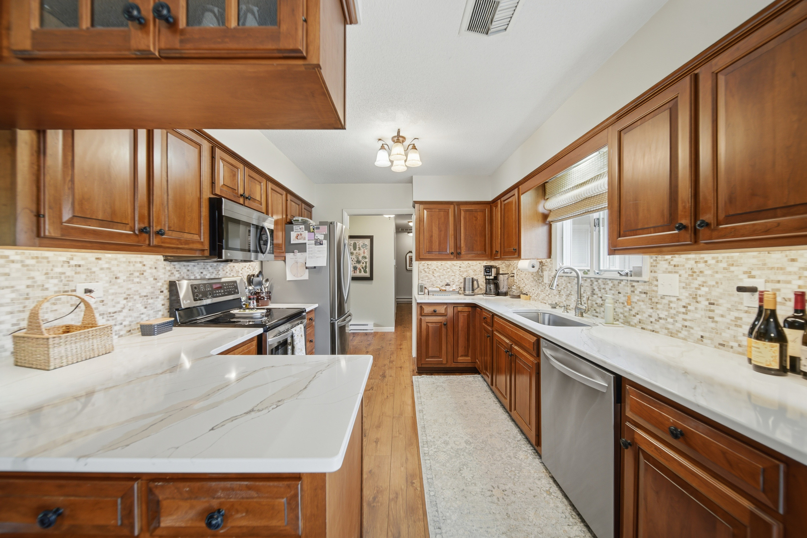 476 Timberland Drive Dixon, IL 61021 - Photo 16 of 32 a kitchen with stainless steel appliances granite countertop a sink refrigerator stove and microwave