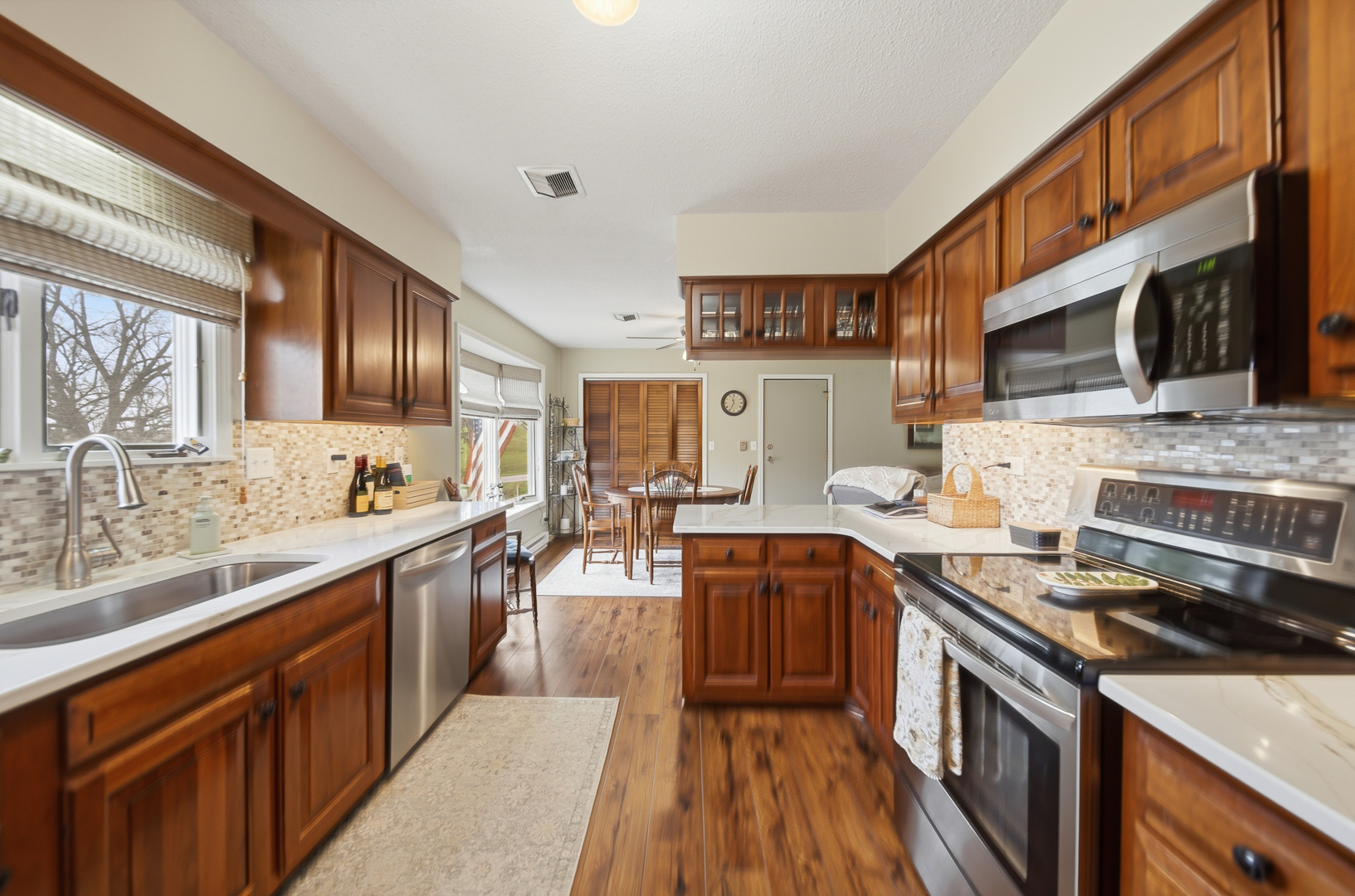 476 Timberland Drive Dixon, IL 61021 - Photo 18 of 32 a large kitchen with stainless steel appliances granite countertop a stove a sink dishwasher and a microwave oven with cabinets