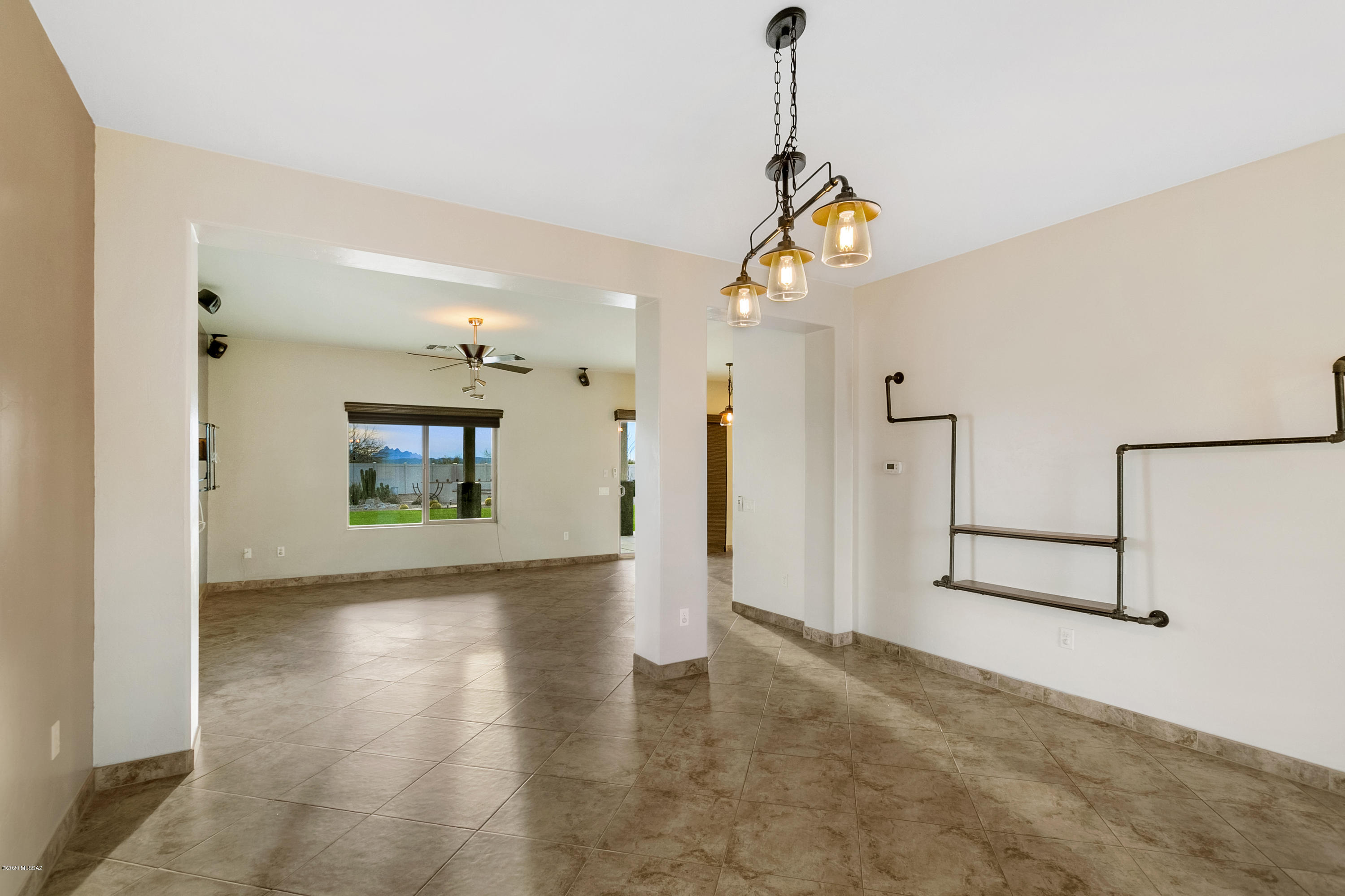 21027 East Treasure Road Red Rock, AZ 85145 - Photo 8 of 29 a view of a hallway with wooden floor and a chandelier