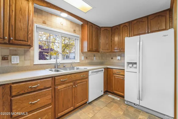 a kitchen with stainless steel appliances a refrigerator sink and cabinets