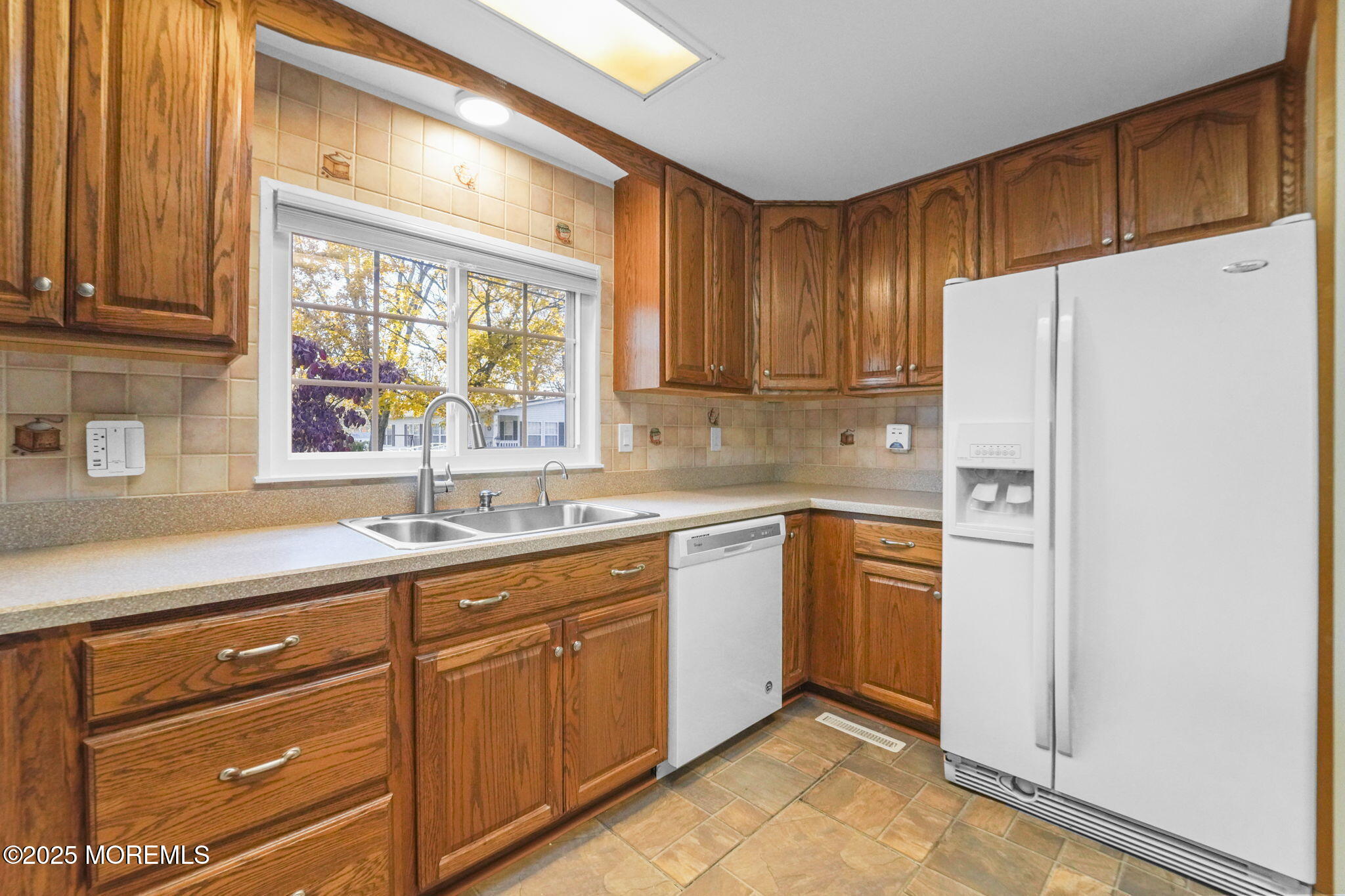a kitchen with stainless steel appliances a refrigerator sink and cabinets