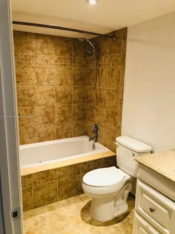 a bathroom with a toilet and a bathtub