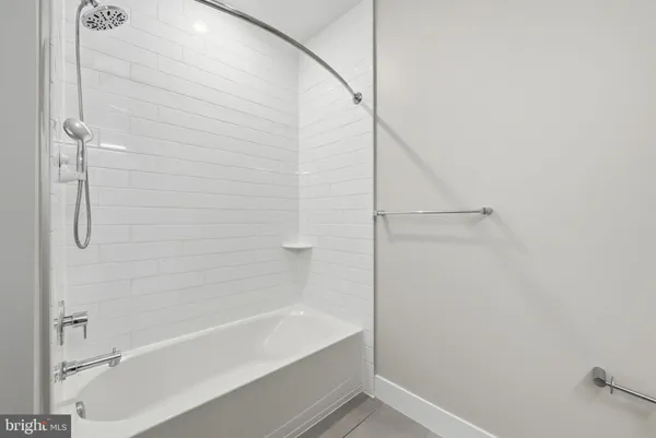 a bathroom with a bathtub and shower