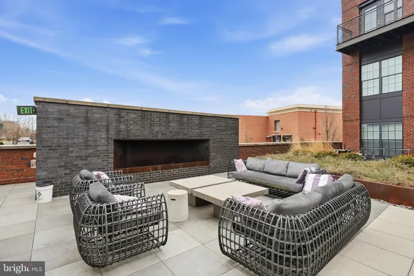 a outdoor living space with furniture and a fireplace