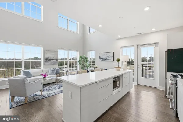 a large white kitchen with a large window
