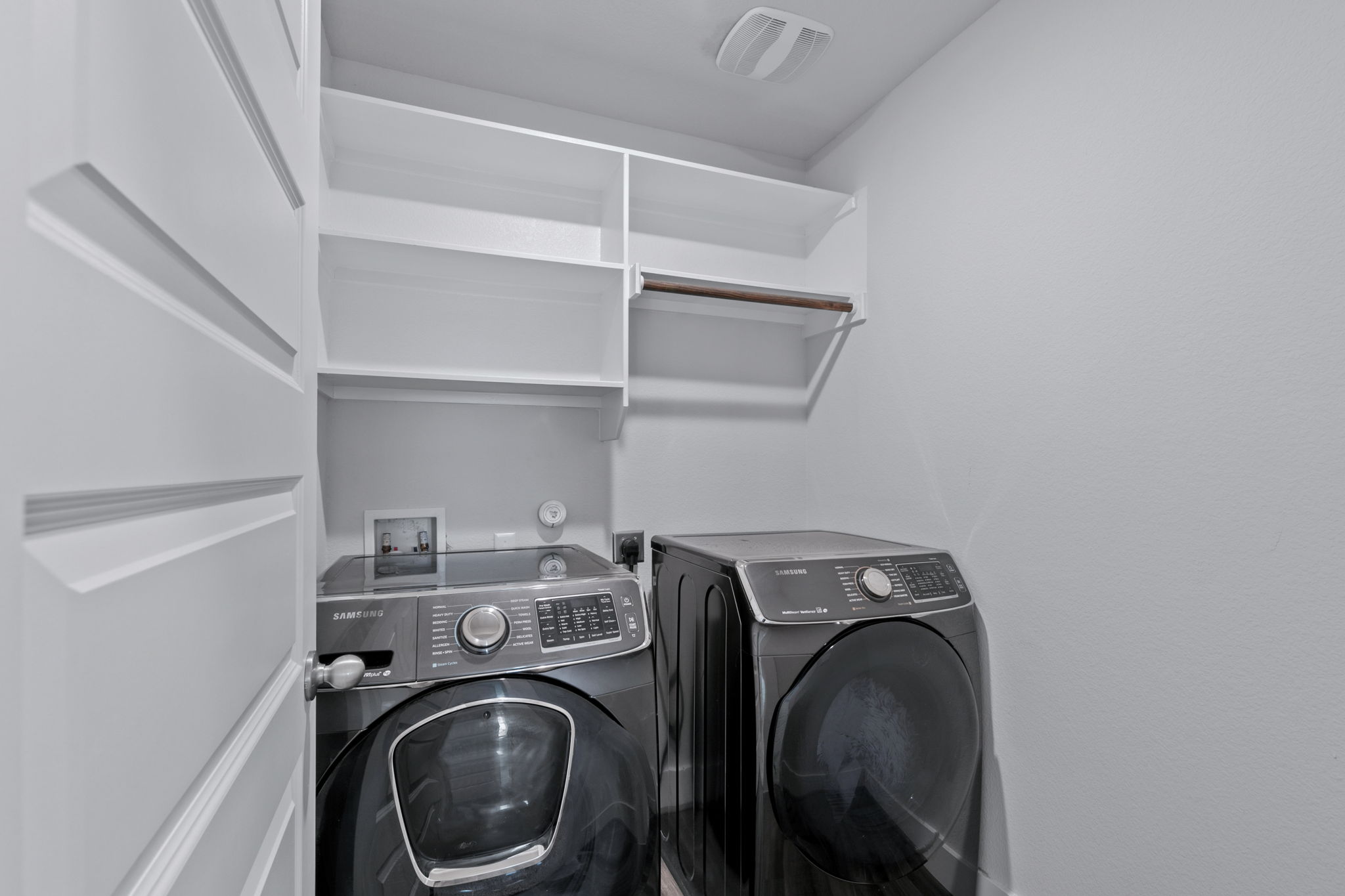 7312 Travertine Spring Drive Austin, TX 78744 - Photo 30 of 32 A dedicated laundry space provides practical storage solutions and essential appliances.