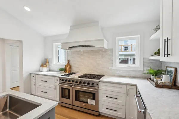 a kitchen with cabinets a stove and a sink