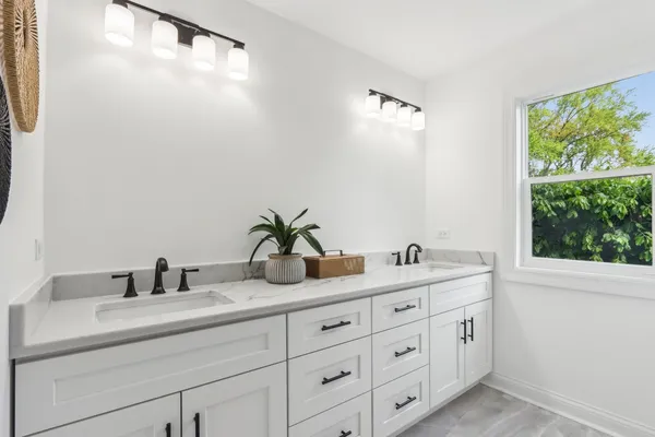 a bathroom with a double vanity sink and a mirror
